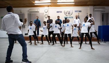 ‪Pour la Journée des Casques bleus, les policiers internationaux de la MINUJUSTH ont célébré la richesse et la diversité des cultures traditionnelles avec de jeunes danseurs haïtiens en partageant des danses haïtiennes, indiennes et népalaises.‬ © Leonora Baumann / UN / MINUJUSTH, 2018
