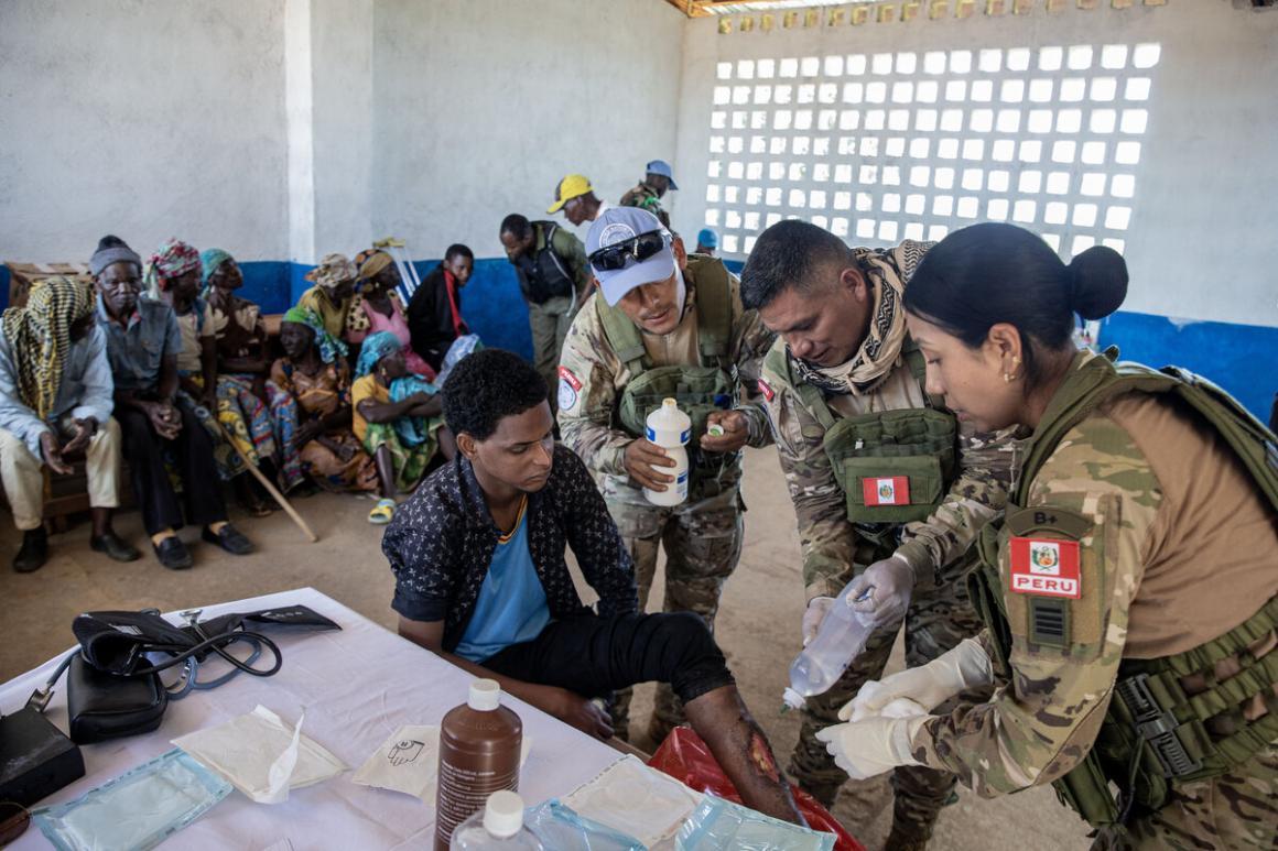 An individual has a wound treated by medics.